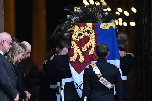 The coffin of the Duchess of Kent, draped in the Royal Standard, is carried into Westminster Cathedral as her husband the Duke of Kent and daughter Lady Helen Taylor bow their heads