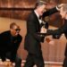 Bryan Cranston, right, presents the award for outstanding talk series to Stephen Colbert, left, for "The Late Show with Stephen Colbert" during the 77th Primetime Emmy Awards on Sunday, Sept. 14, 2025, at the Peacock Theater in Los Angeles. (AP Photo/Chris Pizzello)