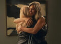 Erin Simkin/Apple TV+ Bradley (Reese Witherspoon) and Alex (Jennifer Aniston) share a hug on 'The Morning Show'