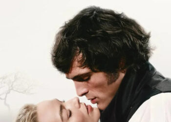 Margot Robbie and Jacob Elordi in a dramatic close up on  a "Wuthering Heights" poster
