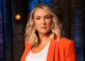 Sara Davies in a red blazer, white top