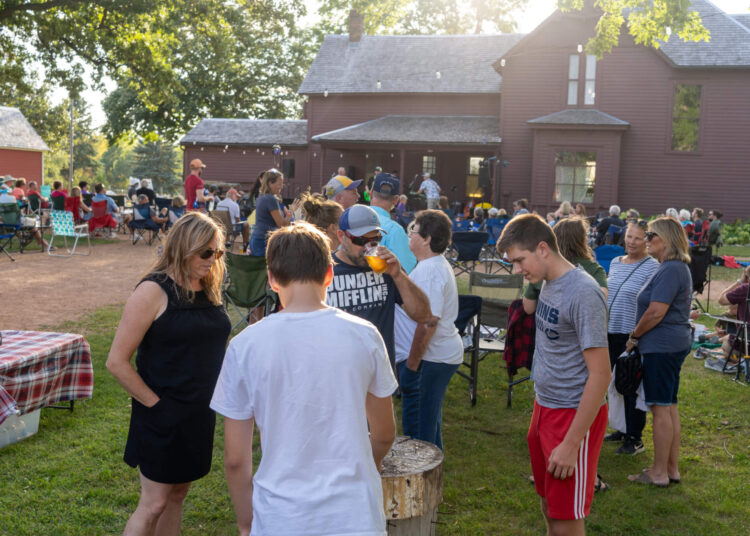 People at a farm, listening to music and enjoying a happy hour