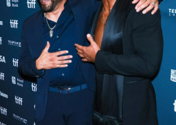 Mark Kerr (left) and Dwayne Johnson pose on the red carpet at the Toronto Film Festival premiere of "The Smashing Machine."