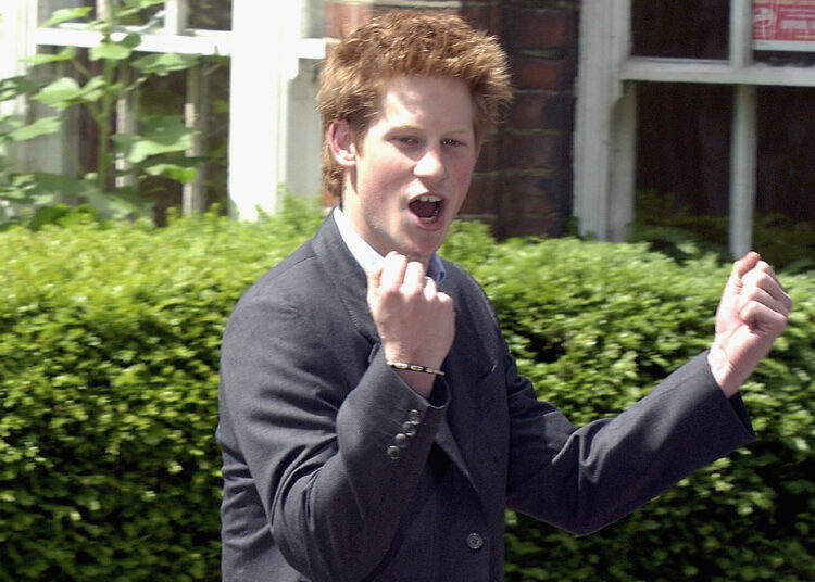 WINDSOR, ENGLAND - JUNE 12: (FILE PHOTO) Prince Harry clenches his fist as he leaves Eton College on June 12, 2003 in Windsor, England. The Royal Family on October 9, 2004 denied allegations that the Prince had cheated in his art A-level. Sarah Forsyth, a former teacher of Harry at Eton, made the allegations as she prepared to take the college to an industrial tribunal claiming unfair dismissal. (Photo by Anwar Hussein/Getty Images)