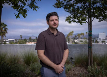 Matthew Tinker, president of David E. Kelley Productions, stands on a rooftop.