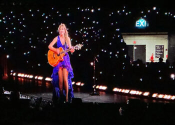 Taylor Swift wore a new blue and purple dress during her surprise, acoustic set during her Eras Tour concert at Hard Rock Stadium in Miami on Saturday, Oct. 19, 2024.