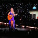 Taylor Swift wore a new blue and purple dress during her surprise, acoustic set during her Eras Tour concert at Hard Rock Stadium in Miami on Saturday, Oct. 19, 2024.