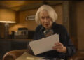 Helen Mirren looking at a clue in The Thursday Murder Club. .