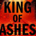 King of Ashes text from book cover over a red-tinted image of train tracks. .