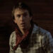 Kevin Costner as Jake wearing a bandana around his neck in a jail cell in Silverado.