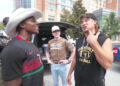 A group of people are standing outside near a vehicle. Streamer IShowSpeed wears a cowboy hat and comedian Theo Von has a sleeveless Vanderbilt Football shirt.