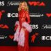 Sabrina Carpenter looked stunning in a sheer red Valentino lace gown, paired with a light pink furry boa. Her look was accessorised with Tiffany & Co. jewellery, and her signature gold locks and dewy makeup.(REUTERS)