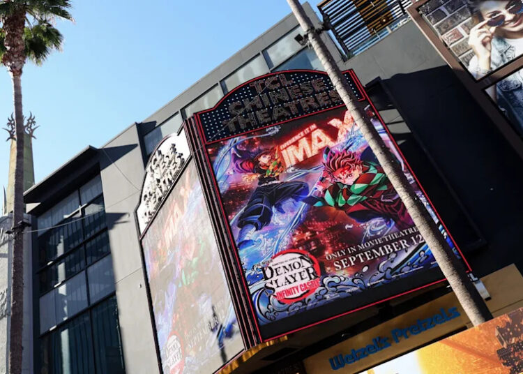 A large IMAX theater marquee displays a