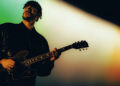Josh Jenkinson of Inhaler plays his 1976 ES-335 live onstage, silhouetted against the stage lights.