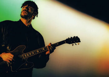 Josh Jenkinson of Inhaler plays his 1976 ES-335 live onstage, silhouetted against the stage lights.