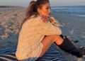 Jennifer Lopez posted on Instagram in a cardigan, lace bloomers/skirt, and lace-up knee-high boots