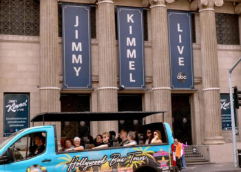 A tour bus drives past the Jimmy Kimmel Theater a day after ABC has pulled the late-night host off air.