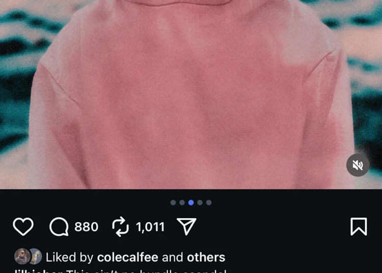 A person in a pink hoodie with a blurred face, against a colorful, abstract background.