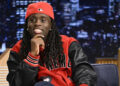 A person wearing a red cap and jacket with