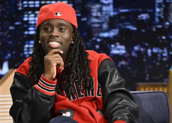 A person wearing a red cap and jacket with