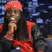 A person wearing a red cap and jacket with