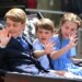 George, Louis, and Charlotte waving to crowds from a carriage