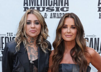 Kyle Richards and Morgan Wade posing in front of a step and repeat.