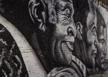 A new mural, depicting actor John Amos, Jr. (center), flanked by his father and son, located at 88 S. Front Street.