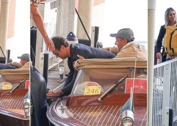 Jude Law, 51, takes a tumble and nearly drops his laptop in the water while stepping off a