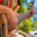 Person strum guitar at outdoor venue