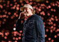 Country singer Morgan Wallen wears blue denim shirt and hat