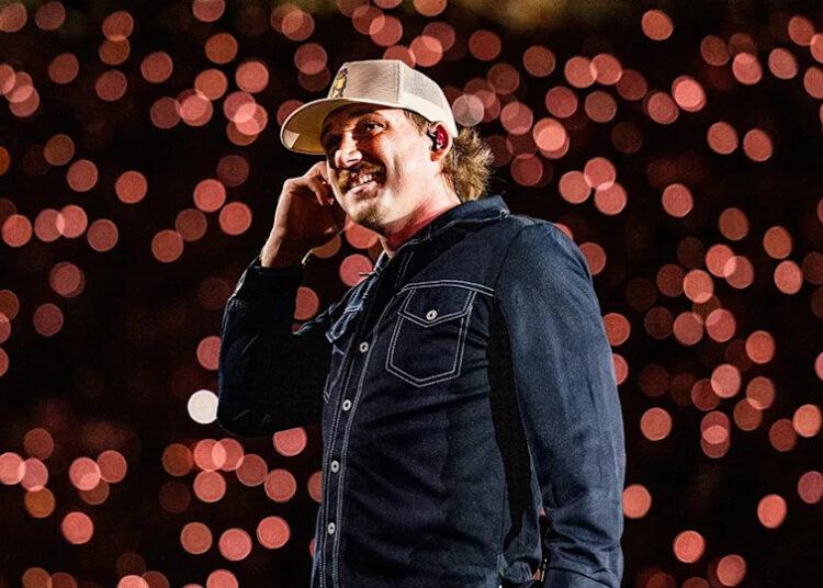 Country singer Morgan Wallen wears blue denim shirt and hat