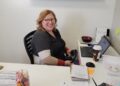 a woman sitting at her desk