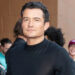 Orlando Bloom in a closeup on a red carpet.