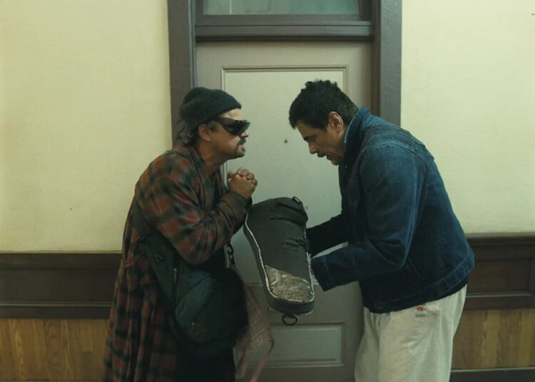 Leonardo DiCaprio as Bob Ferguson and Benicio del Toro as Sensei St. Carlos in "One Battle After Another," a new film from director Paul Thomas Anderson.
