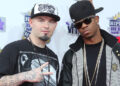 Paul Wall and Chamillionaire posing at a VH1 event, wearing casual hip-hop attire and hats.