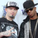 Paul Wall and Chamillionaire posing at a VH1 event, wearing casual hip-hop attire and hats.
