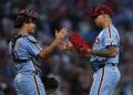 Sep 11, 2025; Philadelphia, Pennsylvania, USA; Philadelphia Phillies pitcher Jhoan Duran (59) and catcher J.T. Realmuto (10) shake hands after a win against the New York Mets at Citizens Bank Park. Mandatory Credit: Bill Streicher-Imagn Images