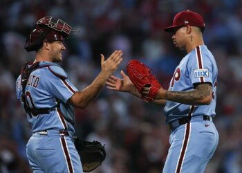 Sep 11, 2025; Philadelphia, Pennsylvania, USA; Philadelphia Phillies pitcher Jhoan Duran (59) and catcher J.T. Realmuto (10) shake hands after a win against the New York Mets at Citizens Bank Park. Mandatory Credit: Bill Streicher-Imagn Images