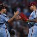 Sep 11, 2025; Philadelphia, Pennsylvania, USA; Philadelphia Phillies pitcher Jhoan Duran (59) and catcher J.T. Realmuto (10) shake hands after a win against the New York Mets at Citizens Bank Park. Mandatory Credit: Bill Streicher-Imagn Images