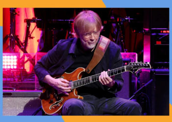 Phish frontman Trey Anastasio noodles on guitar.