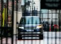 A black SUV drives down a  street
