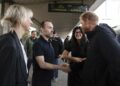 Britain's Prince Harry is greeted at the central railway station in Kyiv, Ukraine, on Friday.