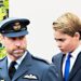Prince William in uniform walking ahead of his son Prince George at VE Day in London.