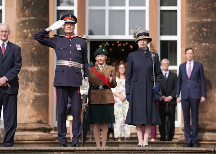 The Princess Royal stands beside NI Secretary Hilary Benn and others outside Hillsbrough Castle.