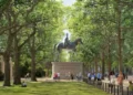 PA Media A mock-up of St James's Park with a large statue of Queen Elizabeth II on horseback high above ground. The statue sits on a plinth in between two rows of tall trees. People are milling about around it and on the pavement off to the right. It is daytime.
