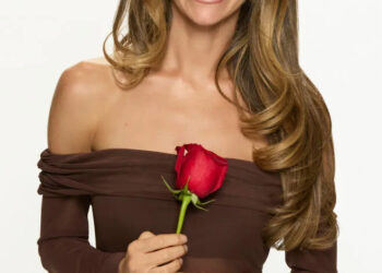 Taylor Frankie Paul posing in a brown off-the-shoulder dress while holding a red rose for The Bachelorette promo photo