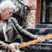 Ricky Byrd wears a weathered biker jacket and throws a pose as he plays a Telecaster on the stoop of a NYC apartment.