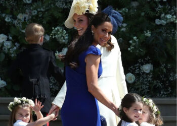Britain’s Catherine, Duchess of Cambridge (in white), and Jessica Mulroney hold bridesmaids’ hands as they arrive for the wedding ceremony of Prince Harry, Duke of Sussex, and Meghan Markle at St George’s Chapel, Windsor Castle, on May 19, 2018.