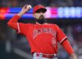 Los Angeles Angels third baseman Anthony Rendon throws the ball into the crowd in the first inning of a baseball game against the Texas Rangers, Tuesday, June 13, 2023, in Arlington, Texas.